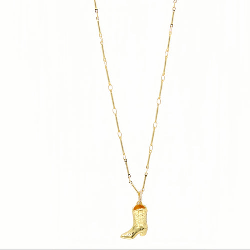 A gold chain necklace featuring a small cowboy boot pendant with a textured western design and a tiny orange accent near the top of the boot, shown against a plain white background.