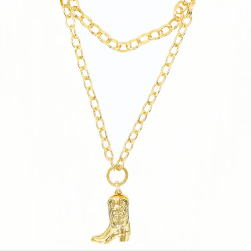 A gold-toned double-layered chain necklace featuring a small cowboy boot charm, displayed against a plain white background.