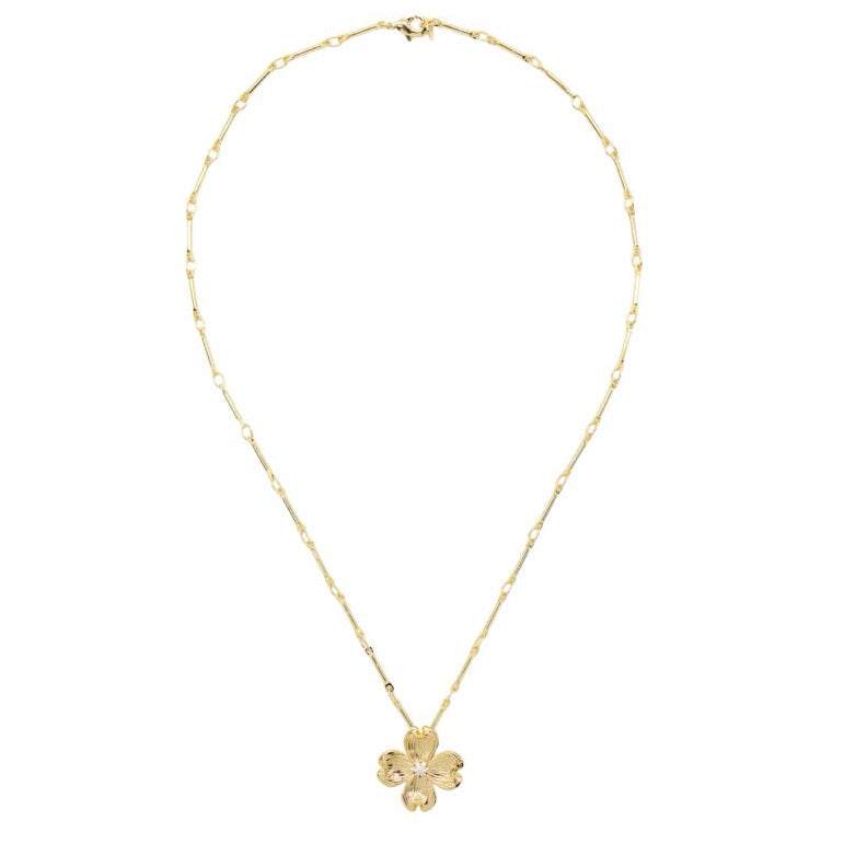 A delicate gold chain necklace with a small four-petal flower pendant, displayed against a solid white background.