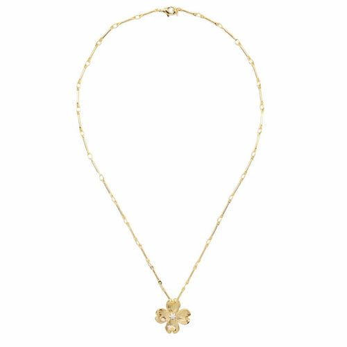 A delicate gold chain necklace with a small four-petal flower pendant, displayed against a solid white background.