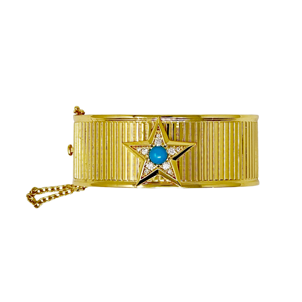 Gold bracelet with a star design and A blue colored gemstone