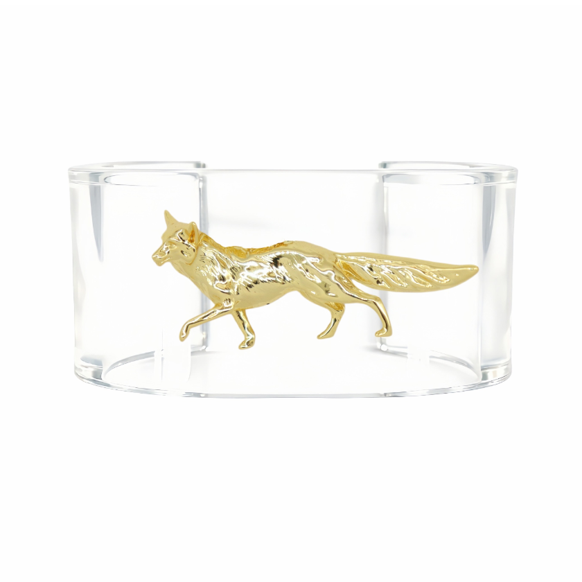 A clear acrylic cuff bracelet featuring a detailed gold fox figurine in the center, set against a plain white background.