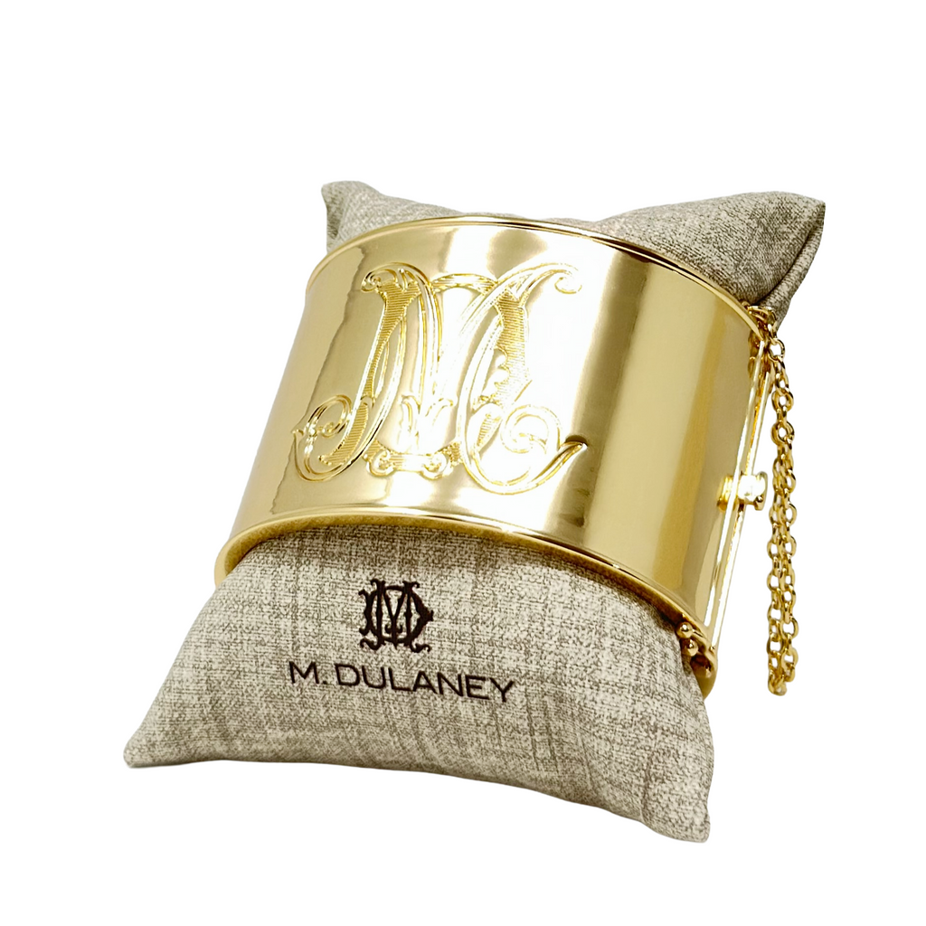 Gold bangle bracelet with a duogram 