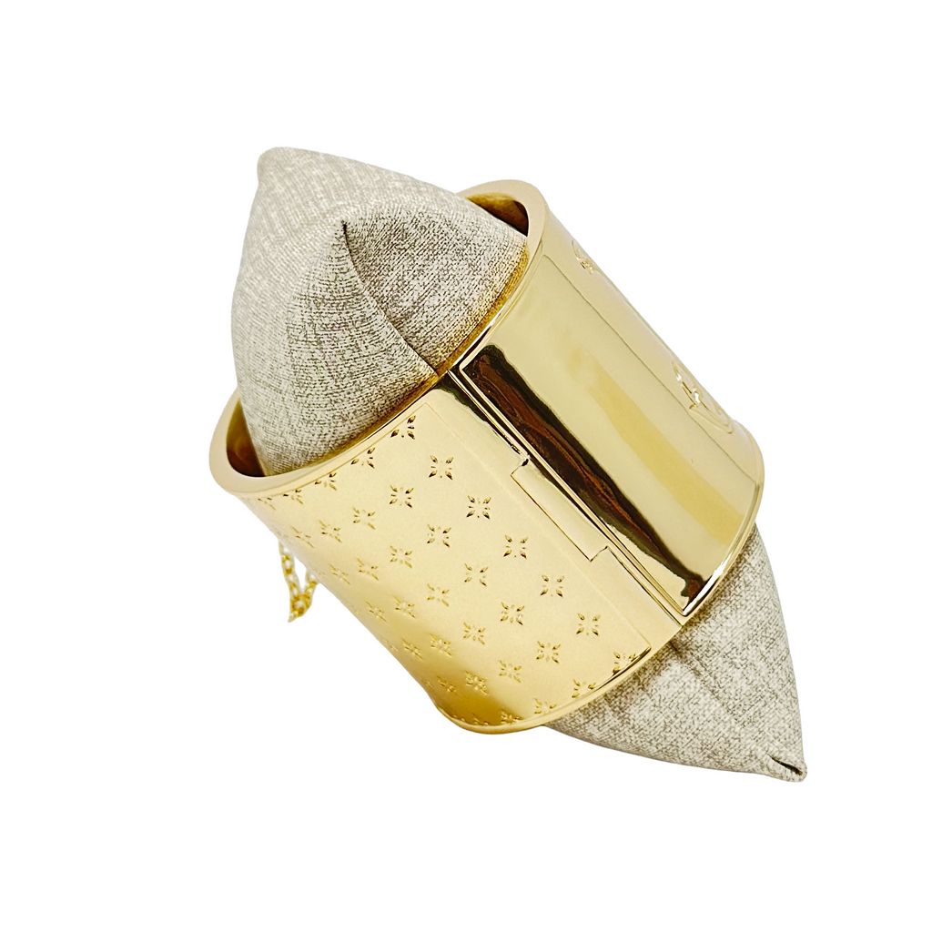 Gold colored bangle showing the hint how it opens