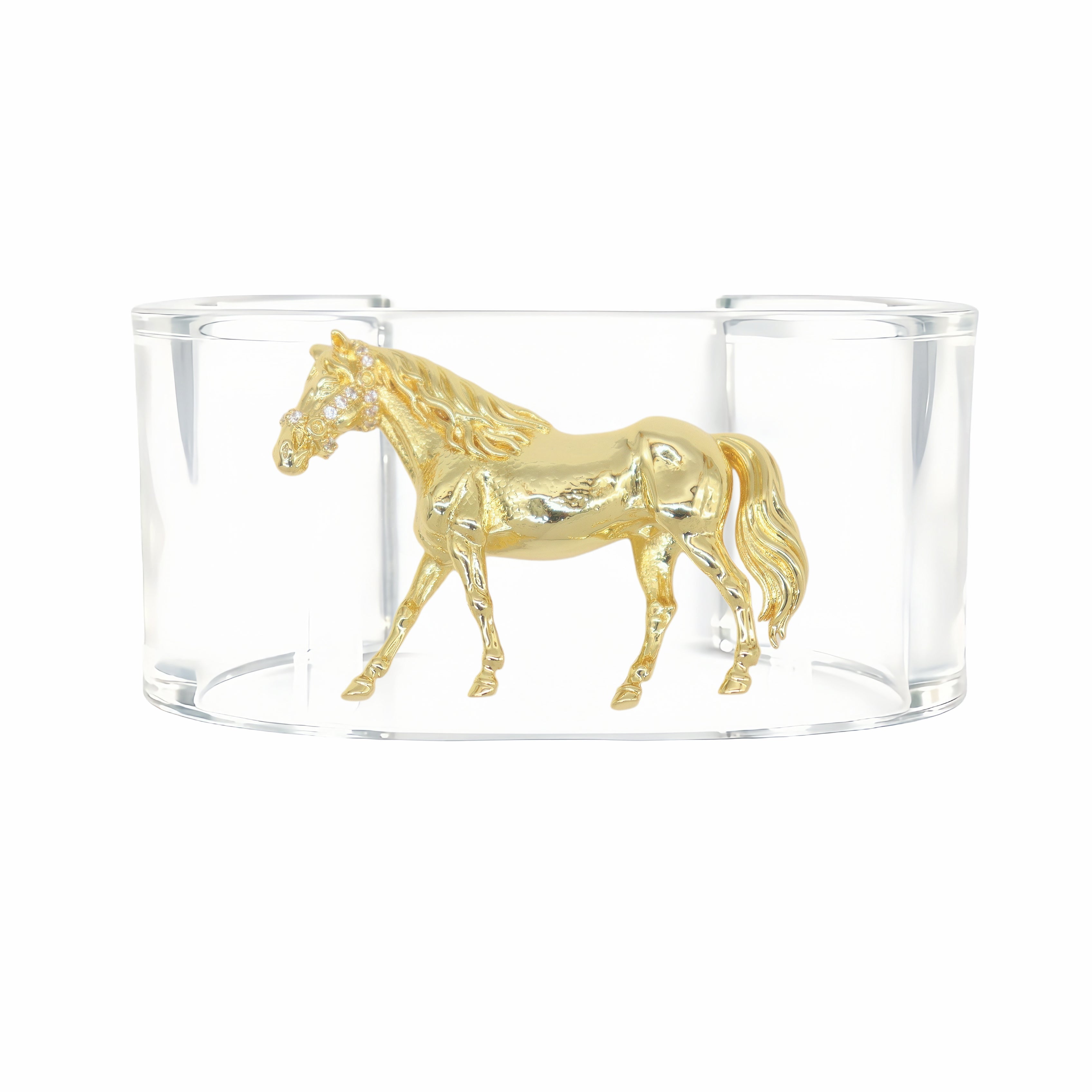A gold horse figurine displayed inside a clear cylindrical glass container on a white background.