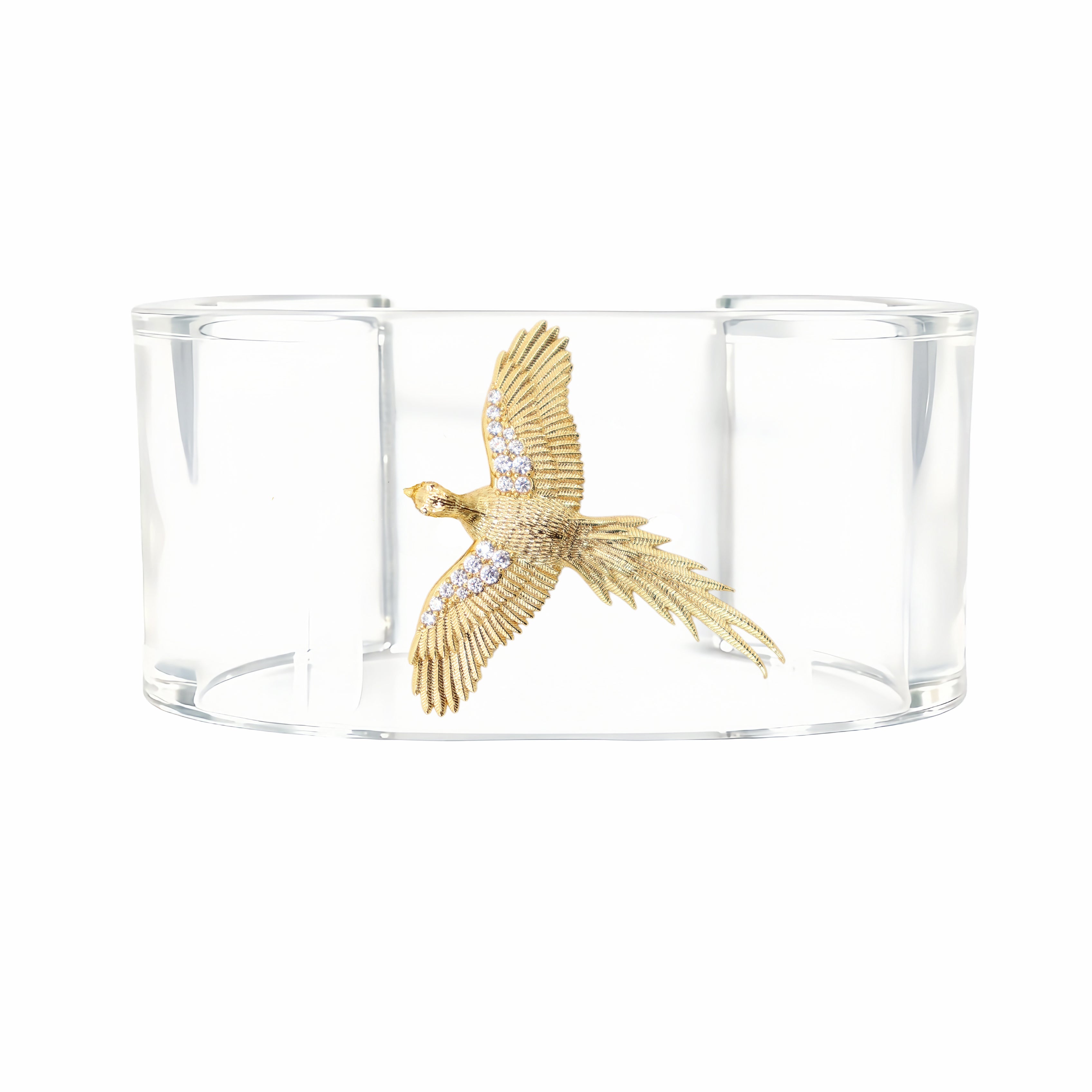 A clear acrylic cuff bracelet featuring a detailed gold bird motif in the center, embellished with small clear stones, set against a plain white background.